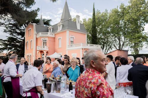Invités réunis devant le domaine familial pendant le cocktail